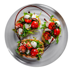 Wall Mural - Italian bruschetta with roasted tomatoes, mozzarella cheese, balsamic vinegar and herbs on plate isolated on white background