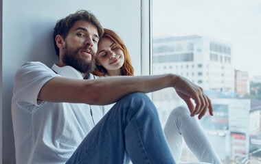 Young family near window rest hugs interior lifestyle