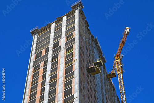 Fototapeta Crane and highrise construction site