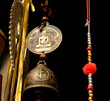 Buddha medal, charm wheel, bell and beads - symbols and signs of indian (hindu) and buddhist religions and tradition, low angle close view.