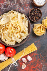 Wall Mural - top view sliced raw dough with seasonings on dark background pasta dough food dark