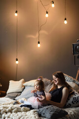 Wall Mural - Mother and daughter have fun together before christmas.