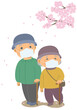 桜を見ながら散歩をしているマスクをつけた老夫婦