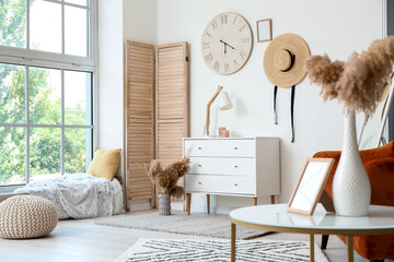 Interior of modern living room with chest of drawers