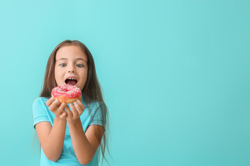 Poster - Cute little girl with sweet donut on color background