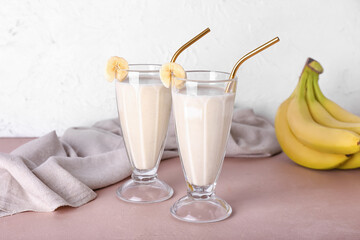 Glasses of tasty banana smoothie on table