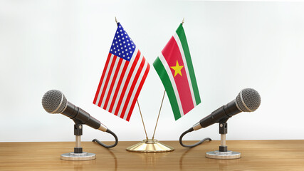 Wall Mural - Microphones and flags pair on a desk over defocused background