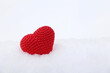 Love heart on a snow. Red knitted symbol of Valentine's day, background for Christmas holiday