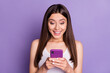 © deagreez - Photo of impressed brown haired young woman wear white singlet good news on media sale isolated on violet color background