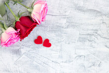 Two Red Hearts And Three Rose On A Stone White Background. Romantic Gift For Valentine's Day. Love. Soft Focus. Copy Space.