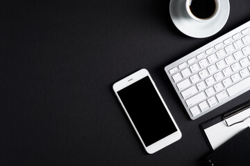 Fototapete - Black office desk table top view with smartphone, keyboard, cup of coffee, clipboard, notepad. Luxury, minimalist style workspace. Flat lay, view from above. Business concept.