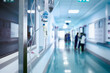 © sudok1 - Intravenous drip in the hospital corridor against the blurred figure of medical staff