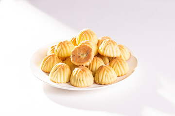 Arabic oriental cookies dates Maamoul in white dish on white background
