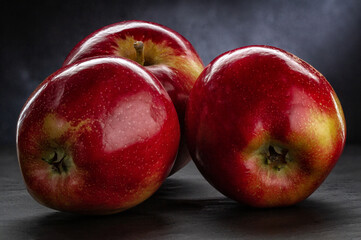 Three juicy red apples close-up