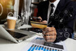 © SOMKID - Business hands using credit cards and digital finance marketing chart, Future technology innovation background, Digital transformation stock marketing concept.