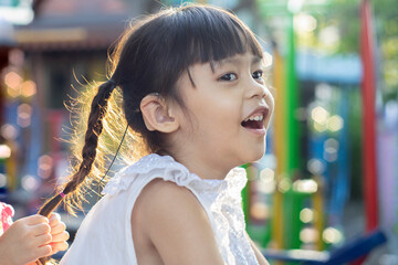 Asian girls wearing a hearing aid Cheerful in the morning.