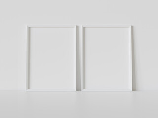 Poster - Two white frames leaning on white floor in interior mockup. Template of pictures framed on a wall 3D rendering