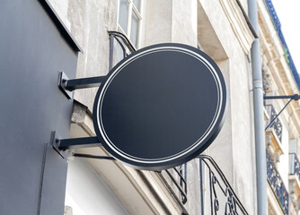 Wall Mural - Circular store brand sign board mockup. Empty shop frontage in street