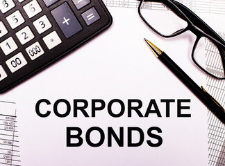 On the reports there is a calculator, glasses, a pen and a notebook with the inscription CORPORATE BONDS