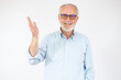 © Danko - Grey haired senior man wearing casual shirt standing over white background smiling cheerful presenting and pointing with palm of hand looking at the camera.