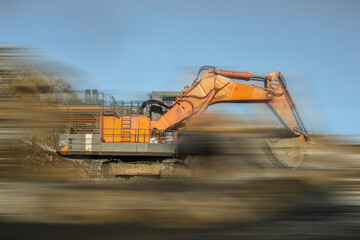 Wall Mural - blurred view of big excavator at worksite of coal mine