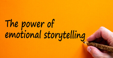 Wall Mural - Power of emotional storytelling symbol. Hand writing 'The power of emotional storytelling', isolated on beautiful orange background. Business and storytelling concept, copy space.