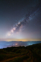 Wall Mural - Milkyway and zodiacal light raise up scene at Phu Chi Fa mountain peak in Chiang Rai, Thailand