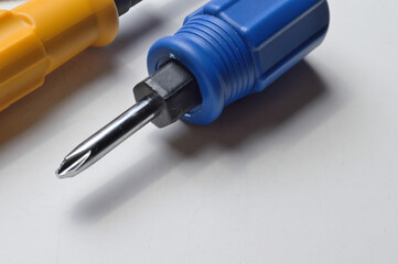 Phillips screwdriver and small screwdriver on white background