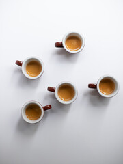 Wall Mural - Five cups of espresso on white background