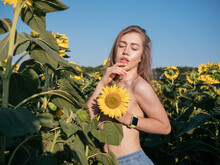 Funny Photo Of Beautiful Woman With Long Hair Smiling And Holding Yellow Sunflower At Sunset. Fun Fermer. Summer Concept