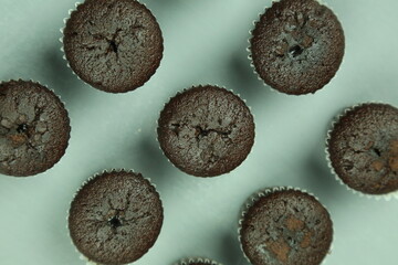 Wall Mural - Chocolate cupcakes with colored background