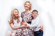 © iordani - happy smiling blond family together posing cheerful on white background, generation concept. lifestyle people