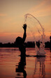 © Andriy Medvediuk - Beauty Model Girl Splashing Water girl Swimming and splashing on summer beach over sunset. Beautiful Woman in Water