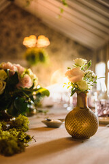 Wall Mural - Beautiful vintage vases with roses as centerpieces of decorating tables of a wedding.