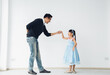 © Me studio - Father is teaching his little daughter to dance in the halls of the house. Happy holidays, family relationships.