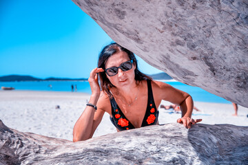 Wall Mural - Young woma touching a tree trunk in the Whitsunday Islands, Australia