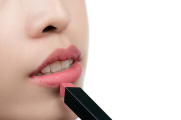 Wall Mural - Close up of asian woman holding or presenting lipstick isolated on white background.