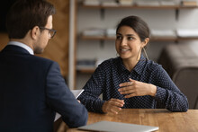 Confident Young Indian Woman Have Recruitment Talk With Male Employer At Office Interview. Ethnic Female Job Candidate Speak With Boss Or Recruiter At Meeting. Employment, Hiring Concept.