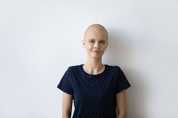 head shot portrait of smiling confident young woman having oncology posing at studio isolated on whi