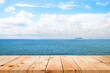 © SizeSquare's - image of Wooden table in front of blue sea and bright landscape