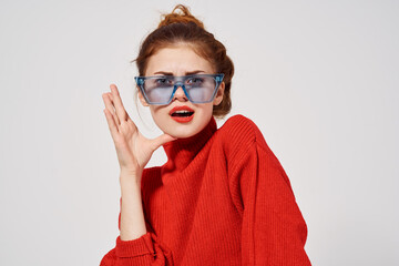 Wall Mural - fashionable woman in blue glasses bright makeup red lips emotions model