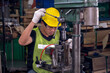 © Sathaporn - Asian manufacturing workers focus while operating  steel drilling machine for make a part of product in manufacturing factory.