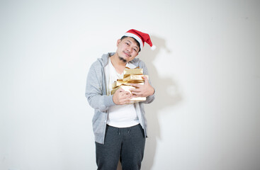 Adorable photo of attractive man with beautiful smile holding a golden gift box
Christmas and New Year concept