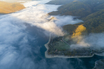  Aerial view of Castel di Tora. Fly through the clouds on Lake Turano.