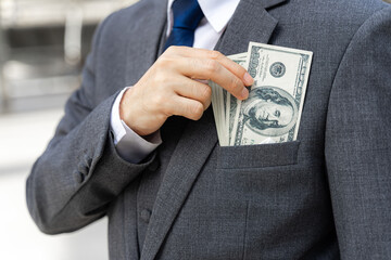 close up business man holding money US dollar bills in hand , concept for rich man  business success