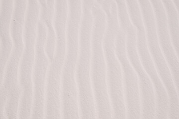 Close up of vertical wavy sand layers at White Sands National Park in New Mexico, USA. Sand texture, sand background, sand wallpaper.  