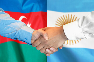 Business handshake on the background of two flags. Men handshake on the background of the Azerbaijan and Argentina flag. Support concept.