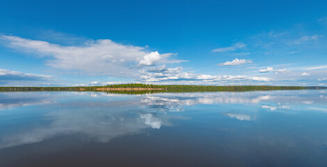 Wall Mural - panorama of calm lake, kama river blue sky with clouds reflected in the water.