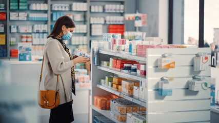 Wall Mural - Pharmacy Drugstore: Portrait of Beautiful Young Woman Wears Protective Face Mask, Searches to Buy Best Medicine, Drugs, Vitamins. Shelves full of Health Care, Welness, Cosmetics, Beauty Products