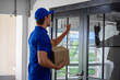 © ake - Caucasian young delivery man with parcel boxes to customer at apartment condominium elevator door. social distancing new normal concept.